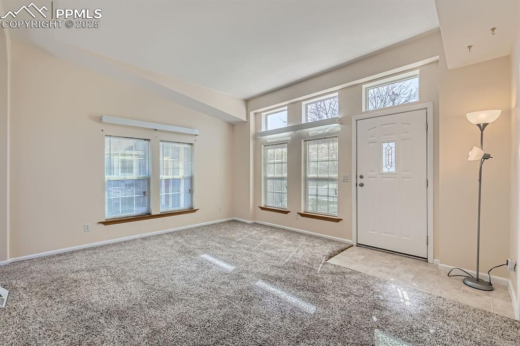 Image 4 of 28: Carpeted entryway with baseboards