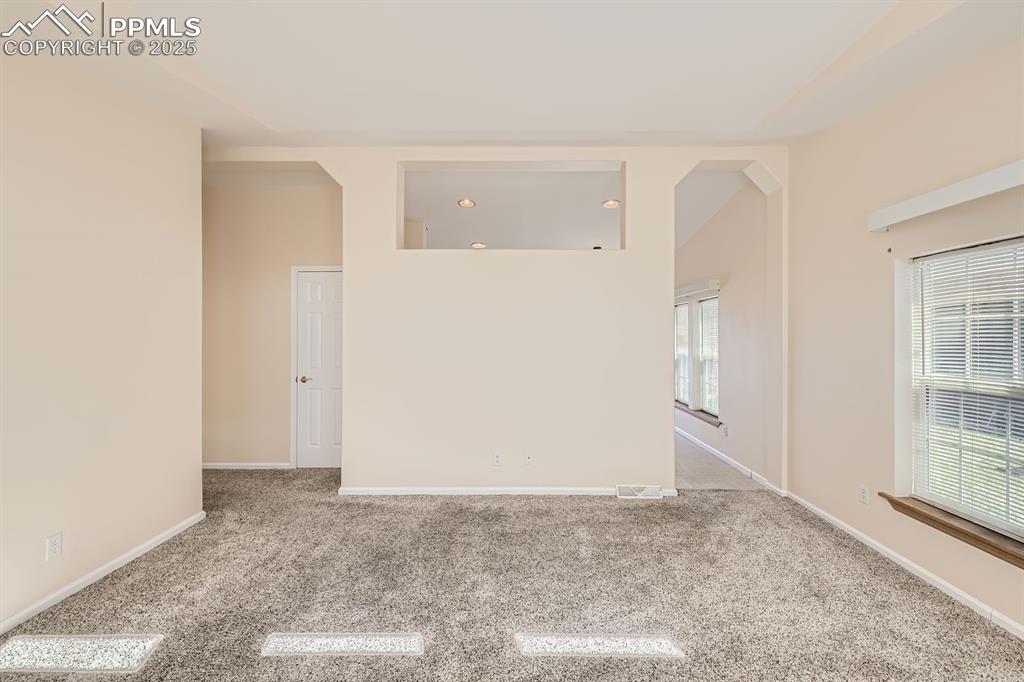 Image 7 of 28: Carpeted spare room featuring baseboards
