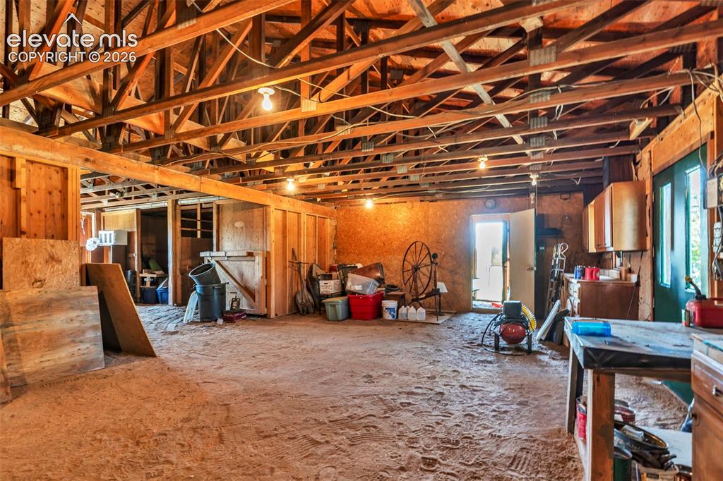 Image 39 of 49: Spacious interior area featuring exposed timber ceiling joists and support