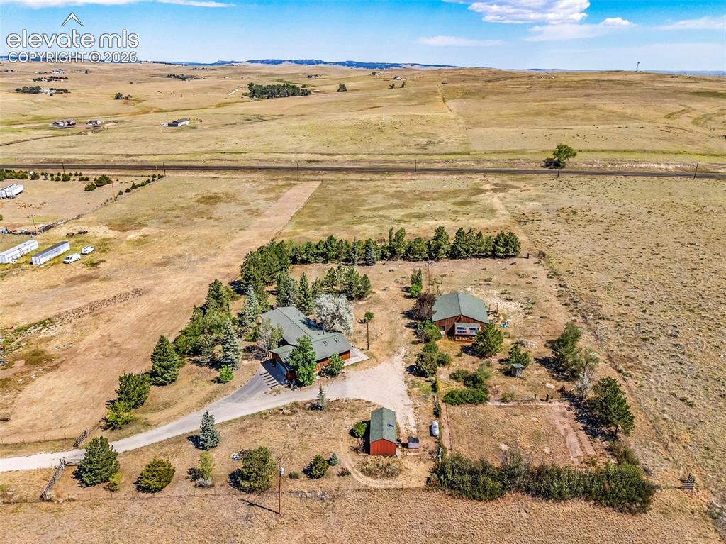 Image 44 of 49: Expansive property featuring two residential structures, a detached shed, m