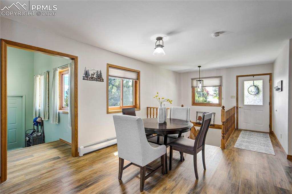 Image 13 of 50: The Dining room with views of entry way and hall to the garage