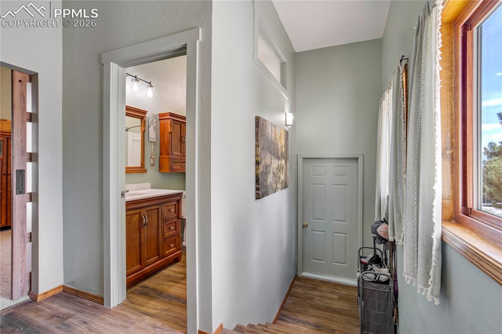 Image 19 of 50: This hallway leads to garage and full bathroom