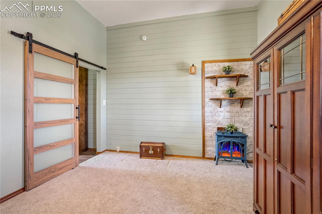 Image 24 of 50: Versatile room with a stylish barn door