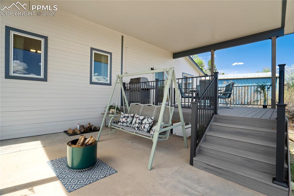 Image 37 of 50: A few steps down from the deck is a 13x17 coverd patio