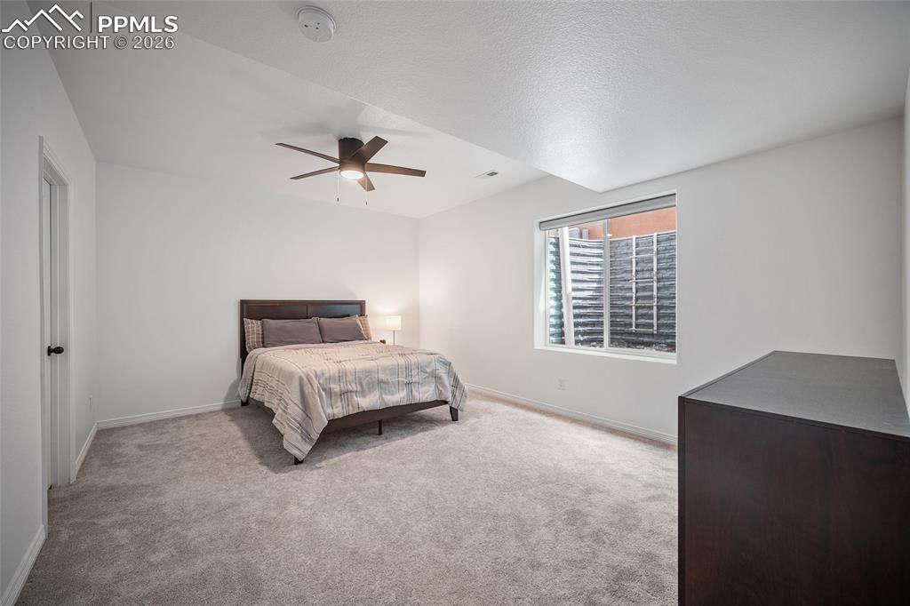Image 38 of 50: Carpeted bedroom featuring baseboards and a ceiling fan
