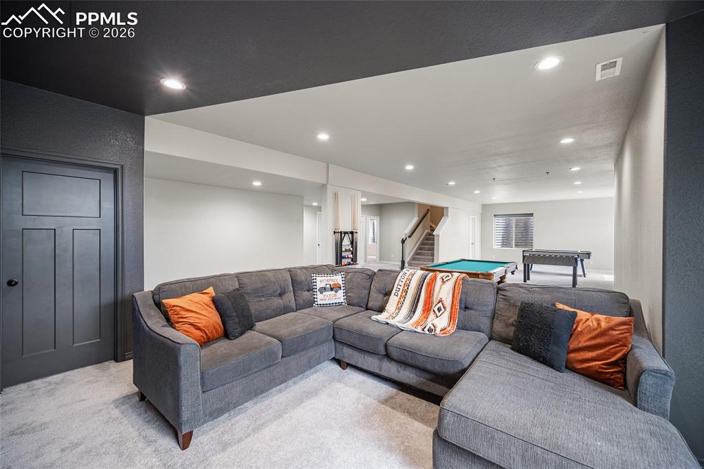 Image 39 of 50: Living area featuring pool table, recessed lighting, stairway, visible vent