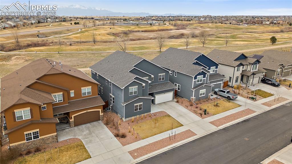 Image 4 of 50: Birds eye view of property featuring golf course and pikes peak view