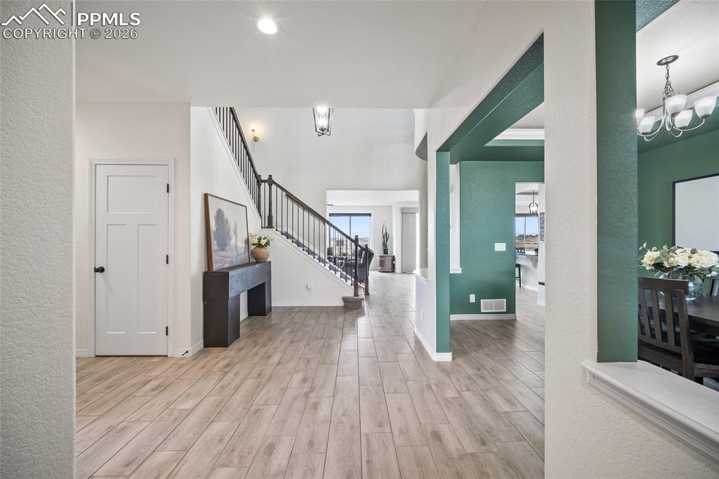 Image 5 of 50: Entrance foyer featuring tall ceilings, formal dining room and office.