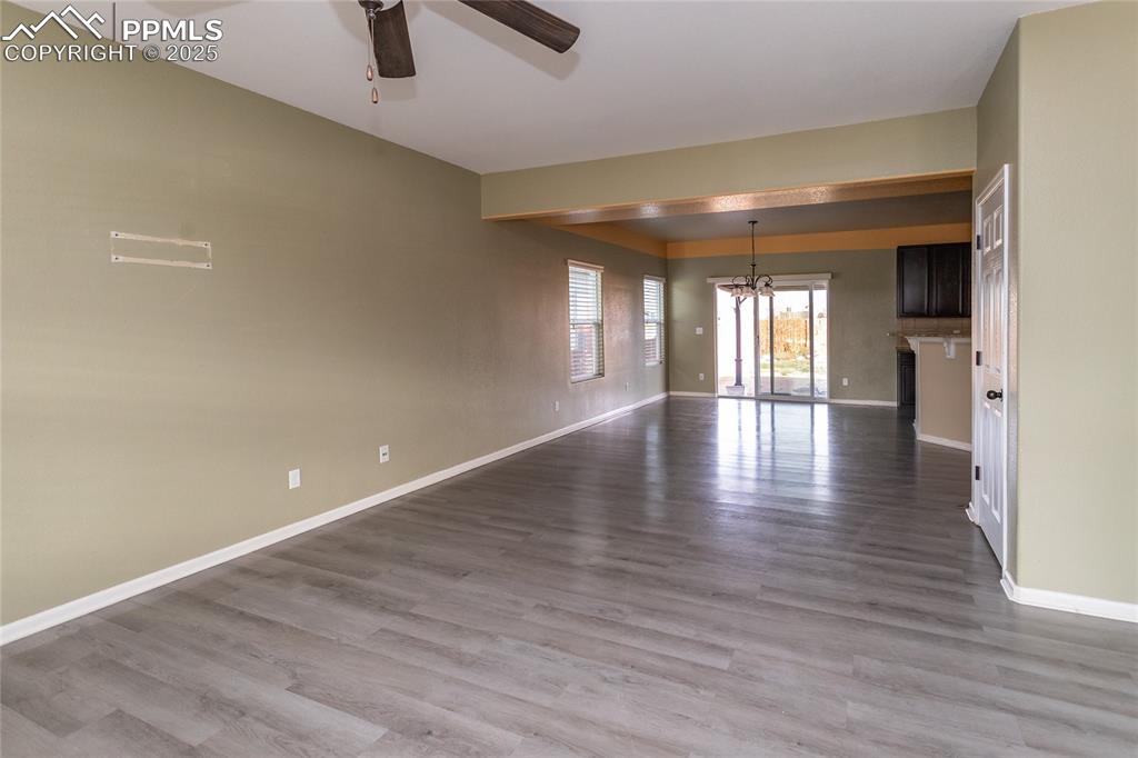Image 10 of 49: living room featuring a chandelier, light wood-style floors, and a ceiling