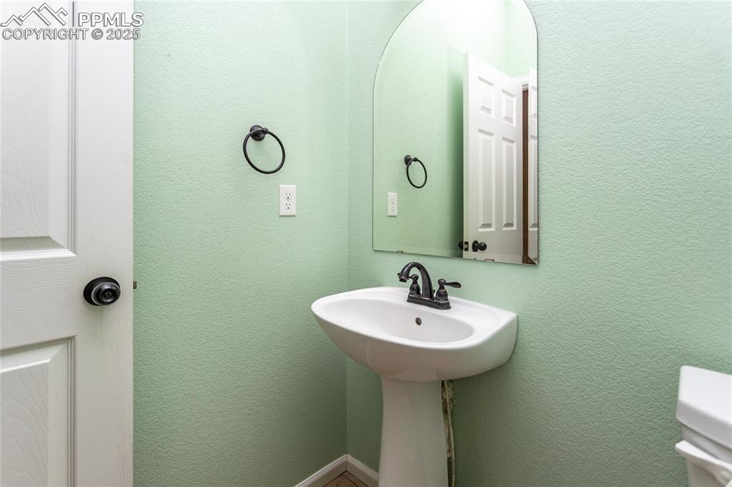 Image 18 of 49: Bathroom featuring a textured wall and toilet