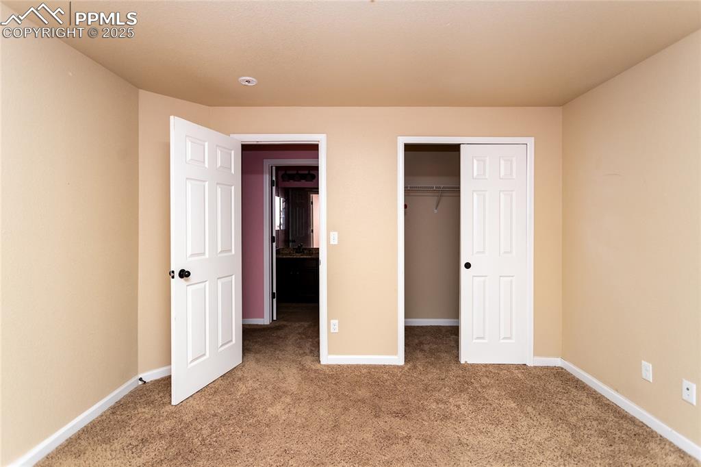 Image 29 of 49: Unfurnished bedroom with light carpet and a closet