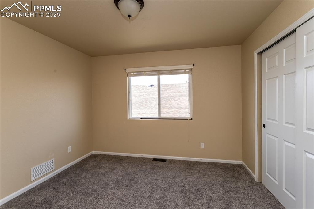 Image 31 of 49: Unfurnished bedroom with carpet flooring and a closet