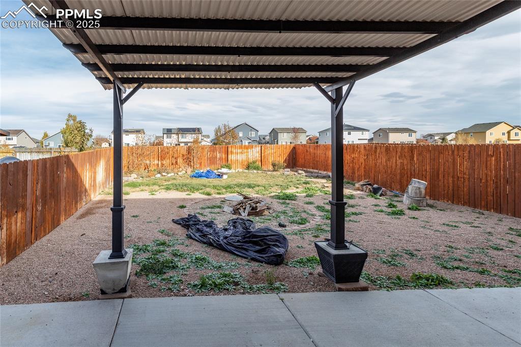 Image 44 of 49: Fenced backyard featuring a residential view