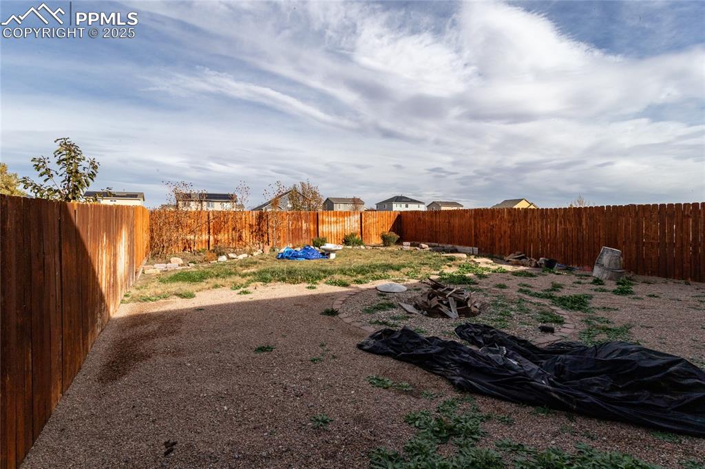 Image 48 of 49: View of fenced backyard