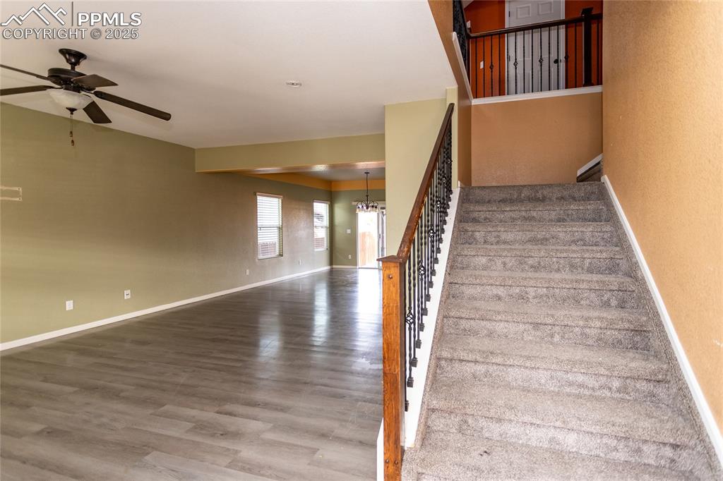 Image 8 of 49: Living room featuring wood finished floors, a ceiling fan, and a textured w