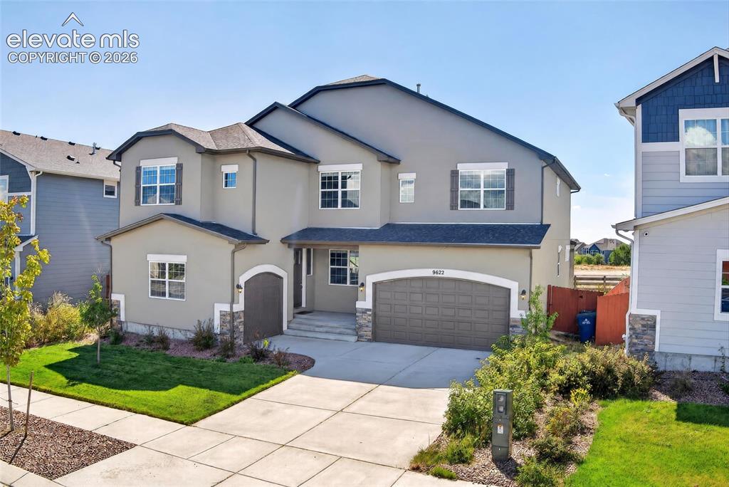 Caption: Stucco exterior with stone accents and dark trim