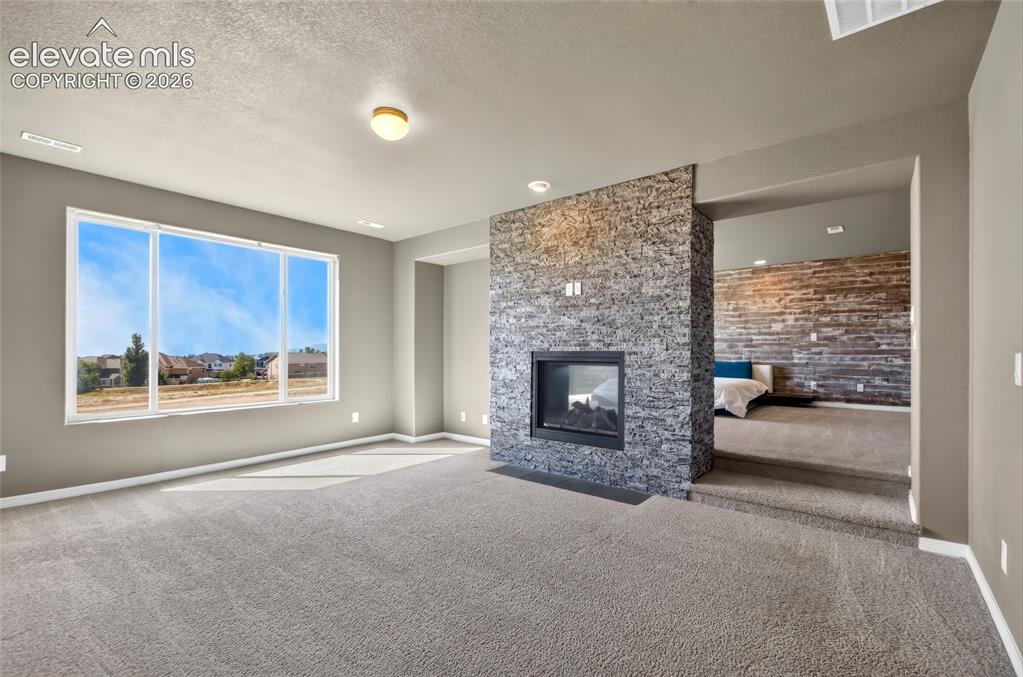 Image 14 of 35: Spacious interior with neutral carpeting
