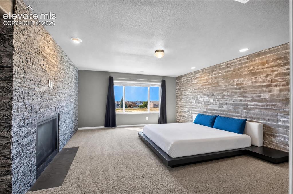 Image 15 of 35: Stone accent wall with a built-in fireplace