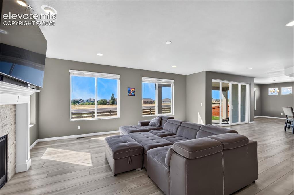 Image 8 of 35: Spacious interior with neutral wall tones, recessed lighting, and wood-fini
