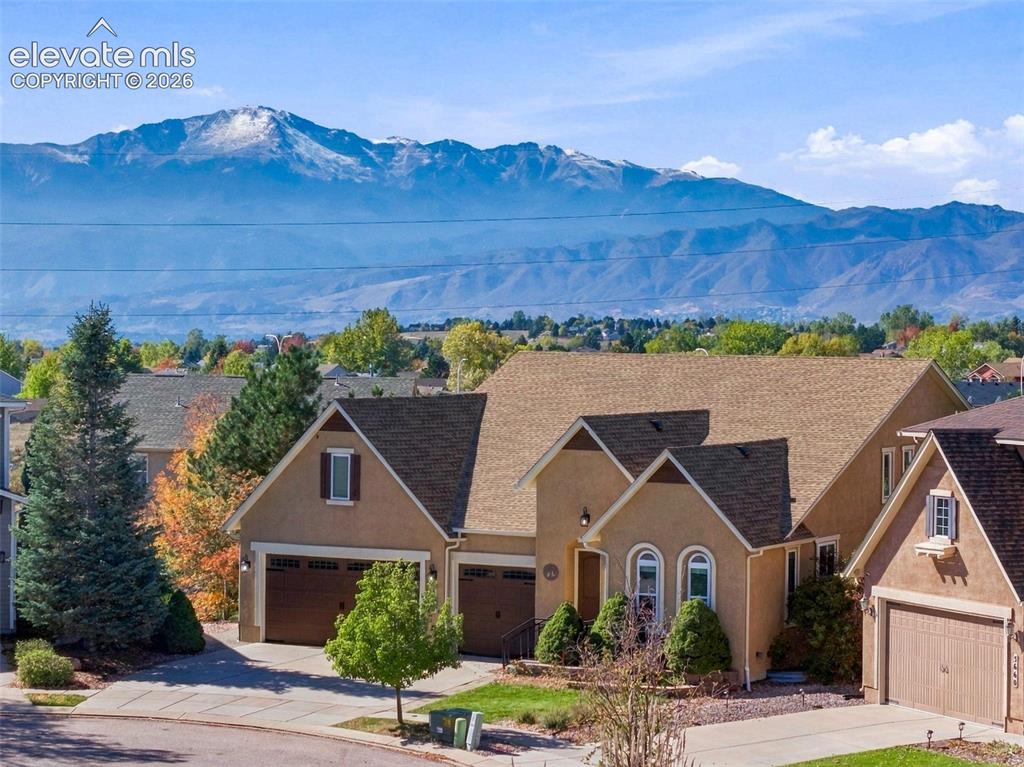 Image 2 of 48: Stucco exterior featuring a multi-gabled roofline, attached multi-car garag