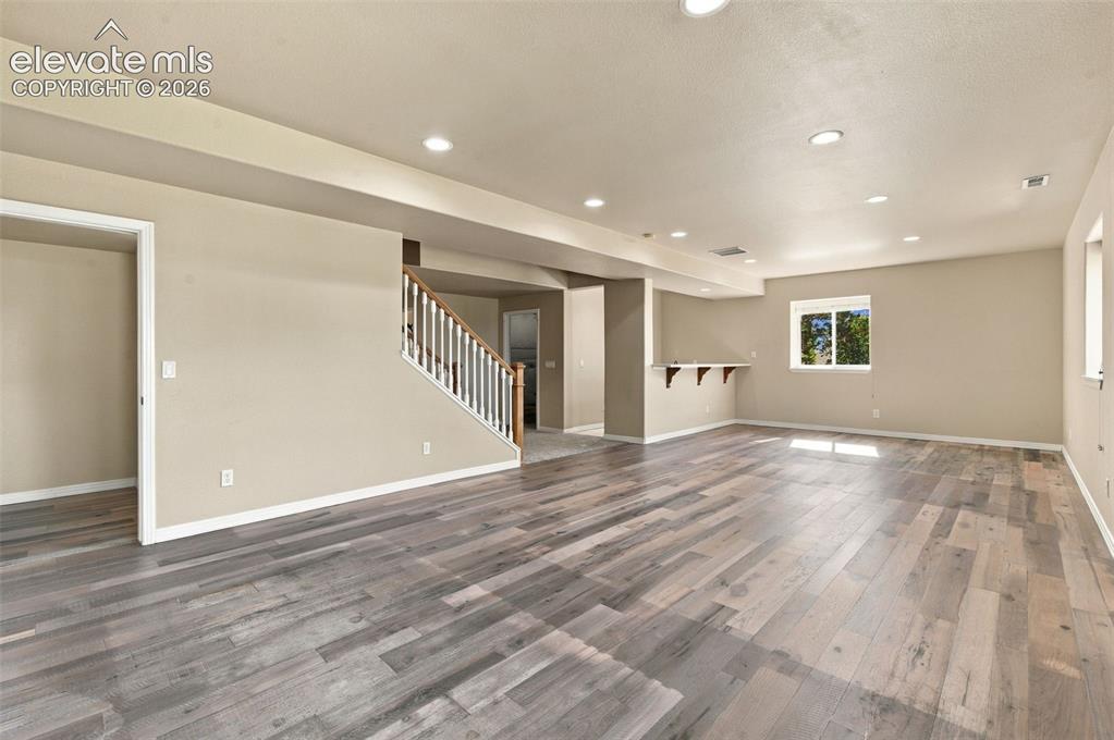 Image 31 of 48: Open-concept interior featuring wood-finish flooring, recessed lighting, a 