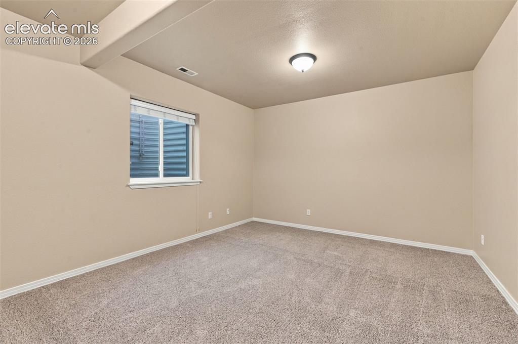 Image 37 of 48: Neutral-toned interior featuring wall-to-wall carpeting, textured wall fini