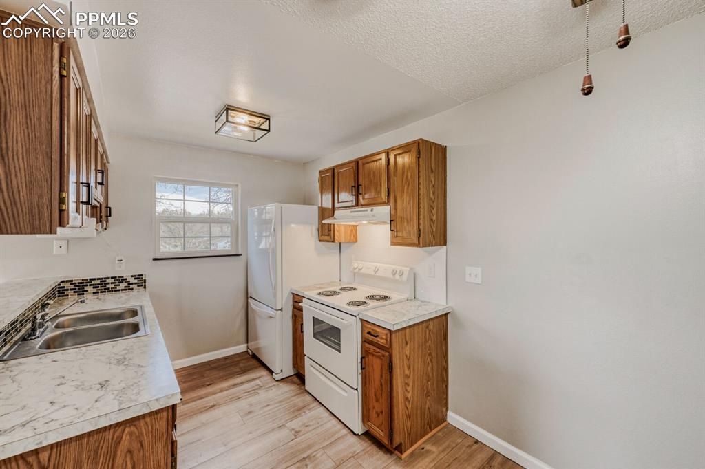 Image 13 of 32: Features newer appliances and countertops