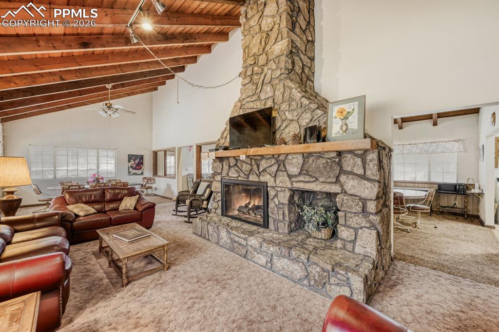 Image 29 of 32: Clubhouse for residents features plenty of seating and a cozy fireplace