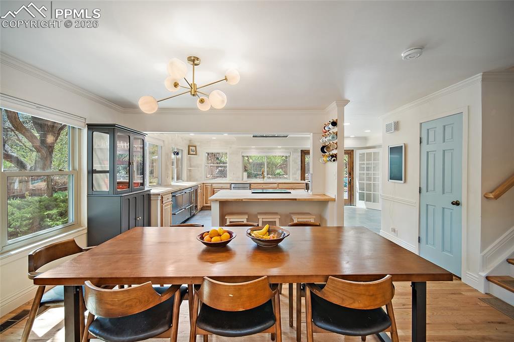 Image 10 of 50: Dining area with cabinets that convey with the sale. 
