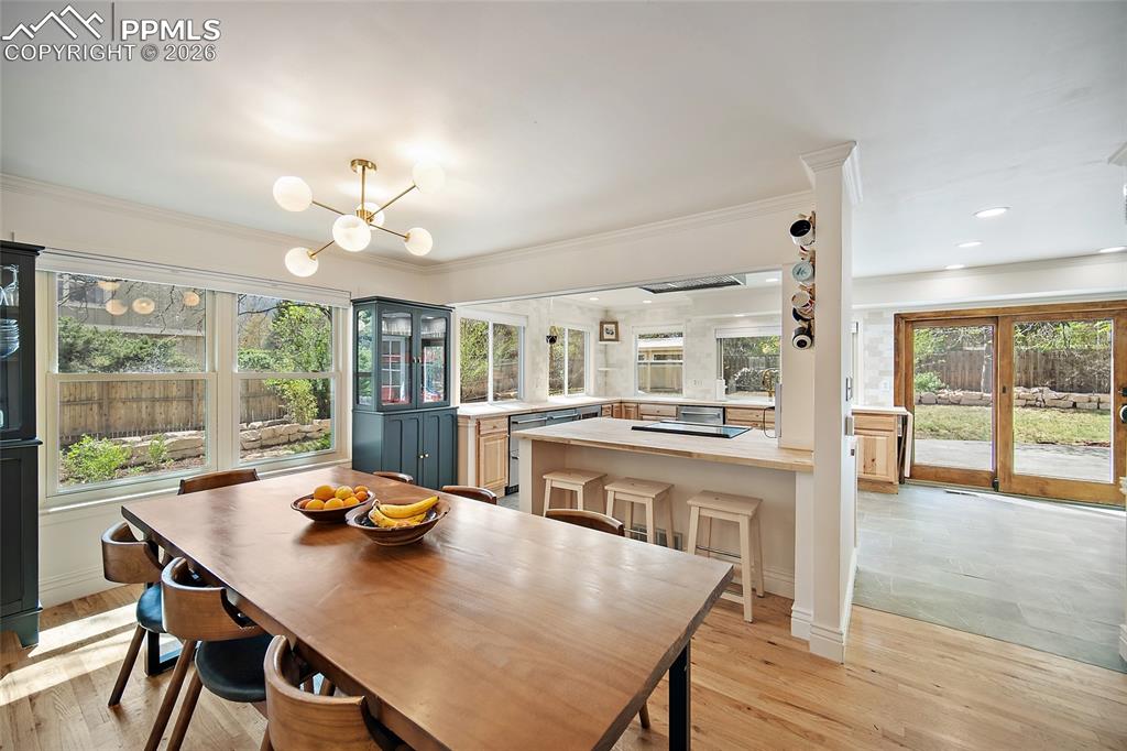 Image 11 of 50: Breakfast bar and green cabinets convey with the sale. 