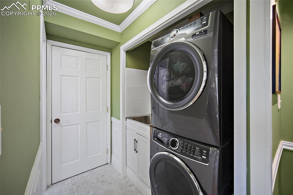 Image 21 of 50: Main level laundry with deep sink.