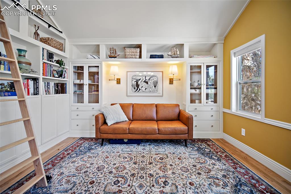 Image 25 of 50: Sitting area in the Primary bedroom with awesome built ins and shelving, go