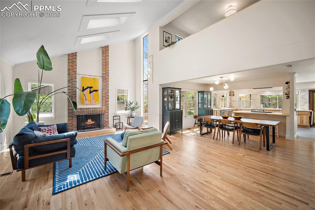 Image 5 of 50: Great room with 4 new skylights and wood burning fireplace with Solid Red O