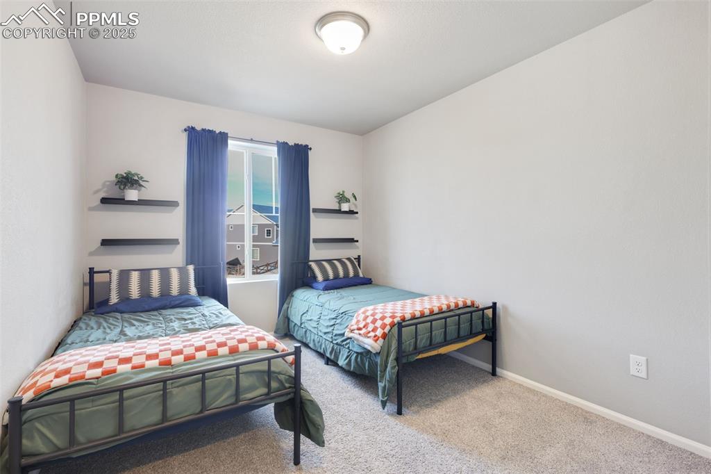 Image 24 of 39: Carpeted bedroom featuring baseboards