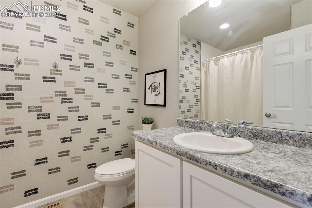 Image 26 of 39: Full bathroom featuring vanity, light wood-type flooring, and a shower with