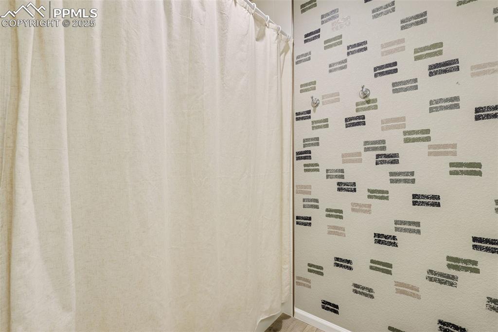 Image 27 of 39: Bathroom featuring curtained shower