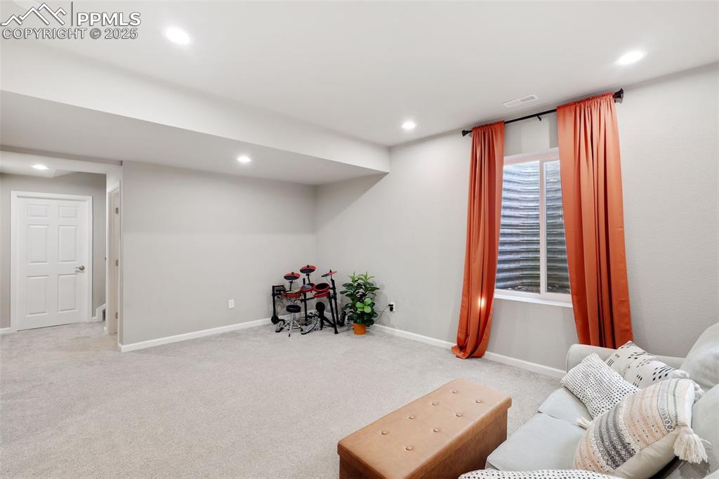 Image 29 of 39: Living area featuring carpet flooring and recessed lighting