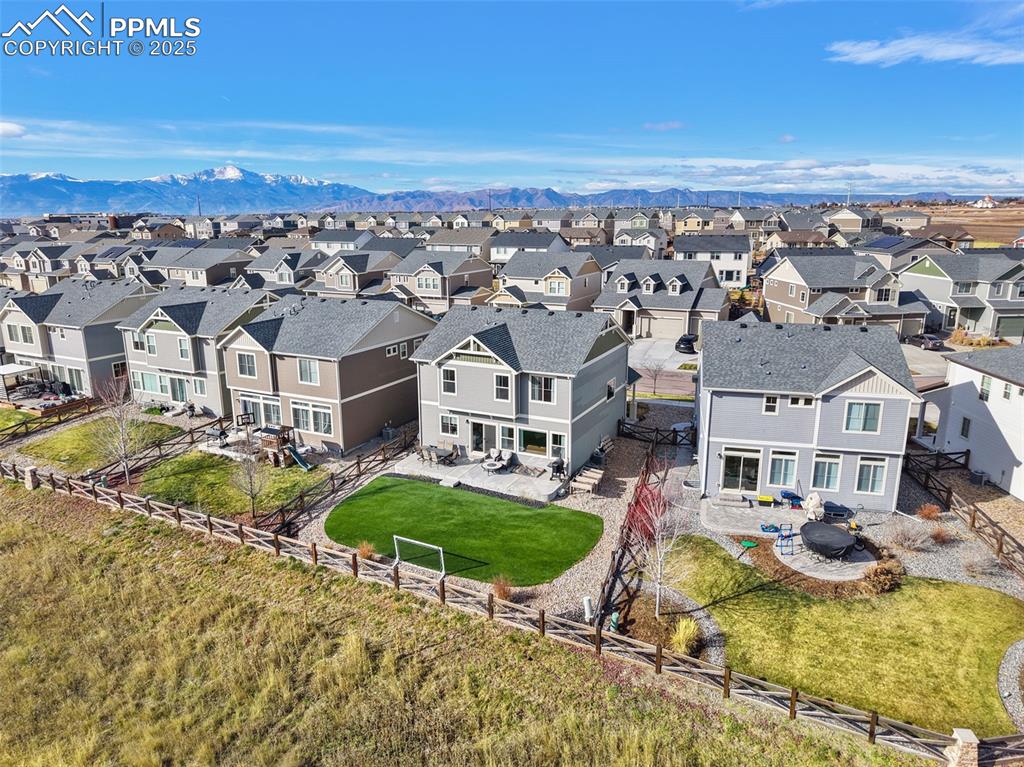 Image 38 of 39: Aerial view of residential area featuring mountains