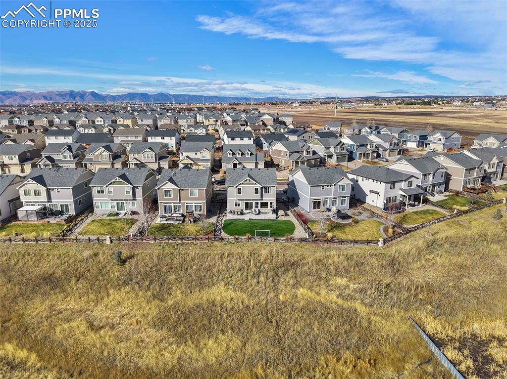 Image 39 of 39: Aerial perspective of suburban area featuring a mountainous background