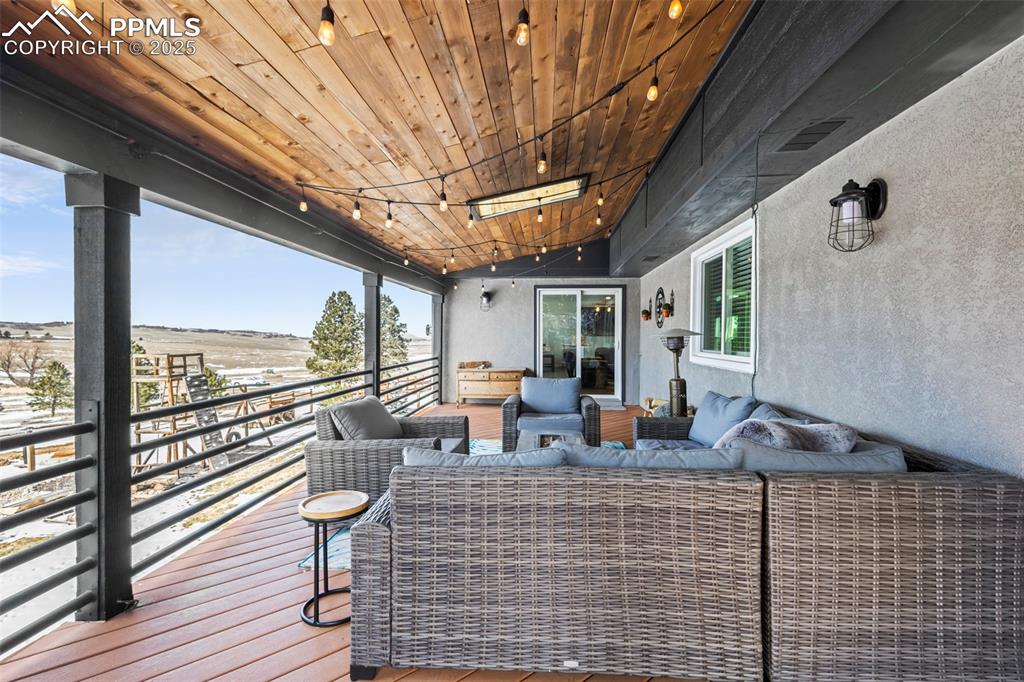 Image 12 of 49: Wooden deck with outdoor lounge area