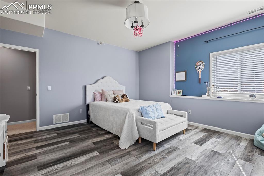 Image 39 of 49: Bedroom featuring dark wood-type flooring, visible vents, and baseboards