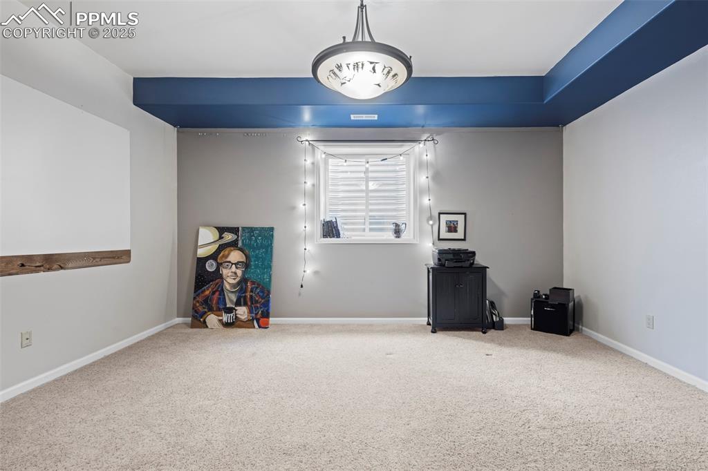 Image 45 of 49: Miscellaneous room featuring carpet and baseboards