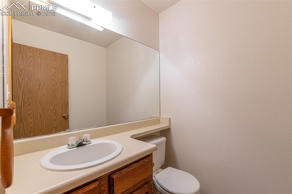 Image 12 of 31: Bathroom with vanity and a textured wall
