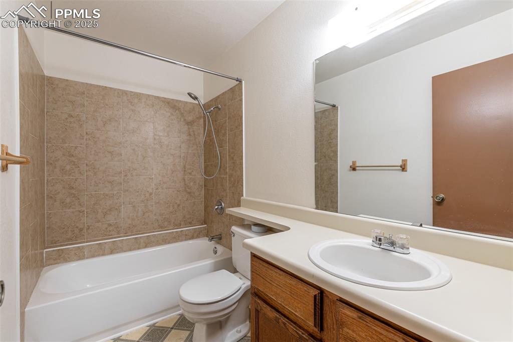 Image 17 of 31: Full bathroom with washtub / shower combination and vanity