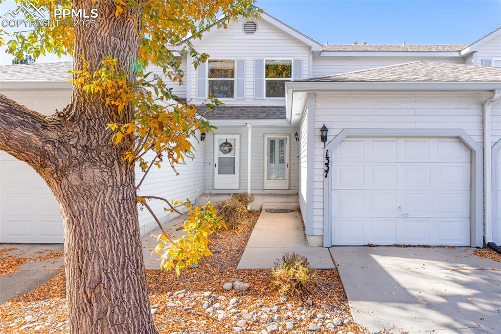 Image 2 of 31: Traditional-style house with roof with shingles, an attached garage, and dr