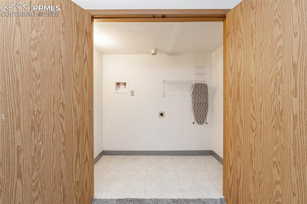 Image 22 of 31: Laundry room with hookup for an electric dryer and washer hookup