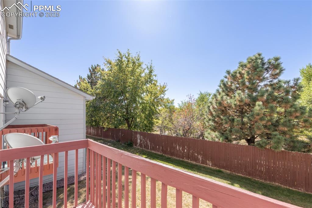Image 25 of 31: Deck with a fenced backyard