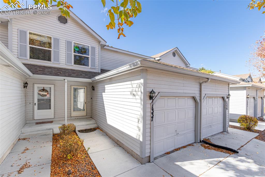Image 3 of 31: Traditional-style home featuring roof with shingles and a garage