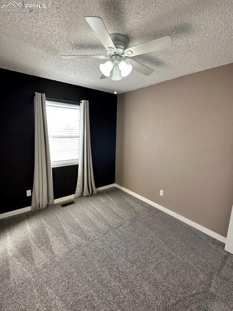 Image 14 of 24: Empty room featuring light carpet, a textured ceiling, and a ceiling fan