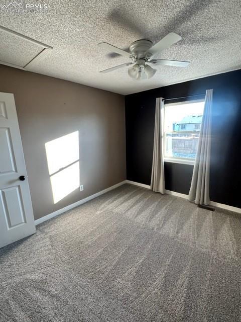 Image 15 of 24: Spare room with carpet flooring, ceiling fan, and a textured ceiling